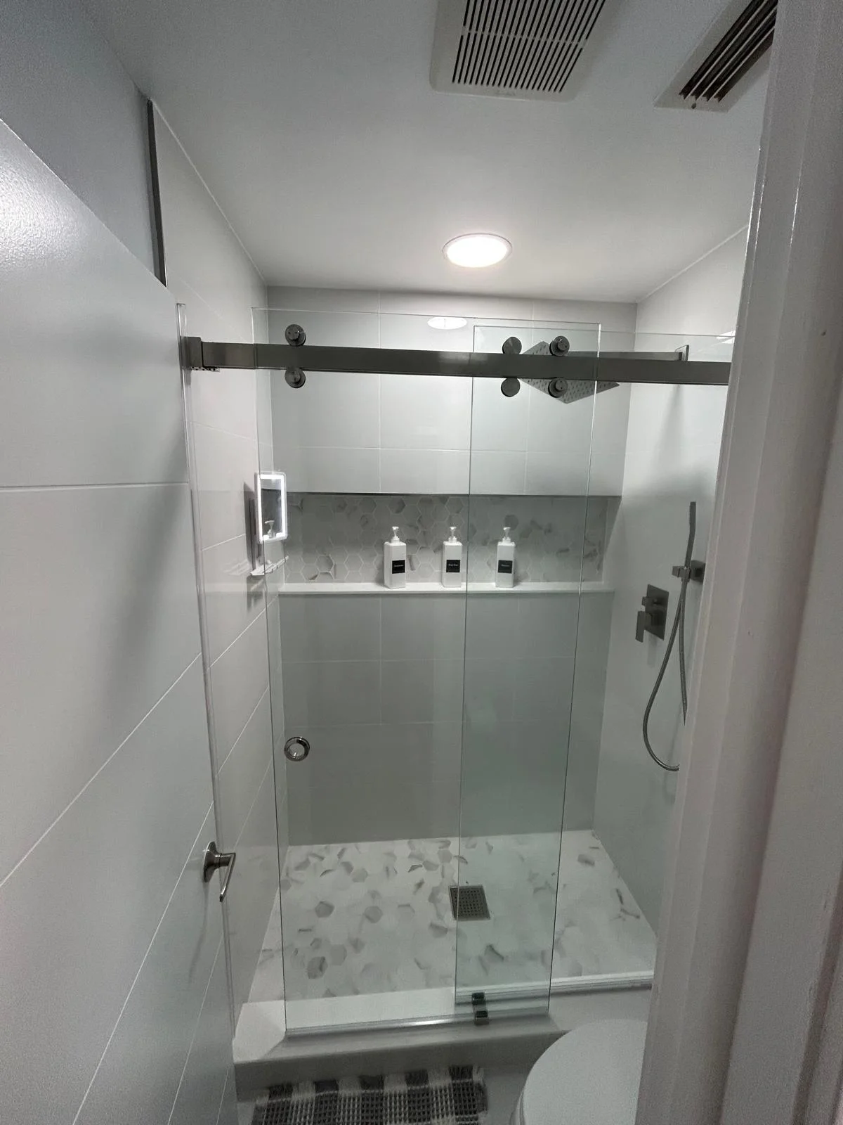 Shower tile and a recessed niche create a practical, refreshed space.